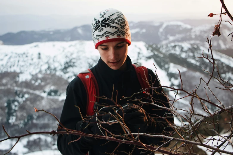 a man standing on top of a snow covered slope, pexels contest winner, symbolism, wearing a beanie, branches growing as hair, avatar image, hiking clothes