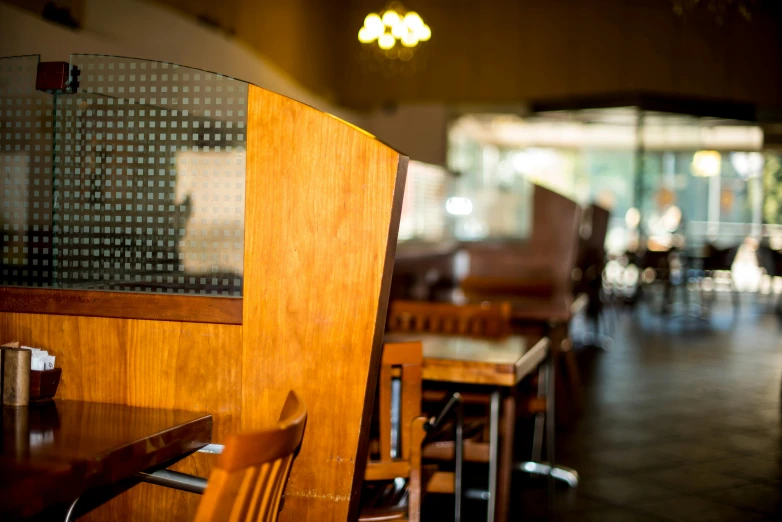 a wooden table and chairs in a restaurant, a portrait, unsplash, fan favorite, california;, pareidolia, in 2 0 1 2