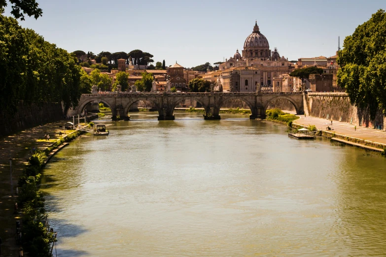 a river running through a lush green forest filled with trees, by Cagnaccio di San Pietro, pexels contest winner, neoclassicism, vatican in background, at the waterside, parce sepulto, overlooking