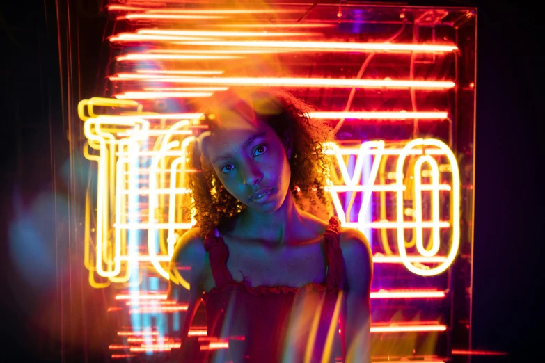 a woman standing in front of a neon sign, pexels contest winner, portrait sophie mudd, girl screamin yolo - aesthetic, red and yellow light, photography from vogue magazine