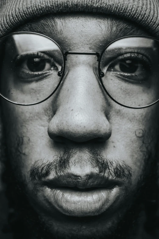 a black and white photo of a man with glasses, inspired by Chuck Close, pexels contest winner, ashteroth, jayson tatum as guerilla heroica, square masculine facial features, high angle closeup portrait