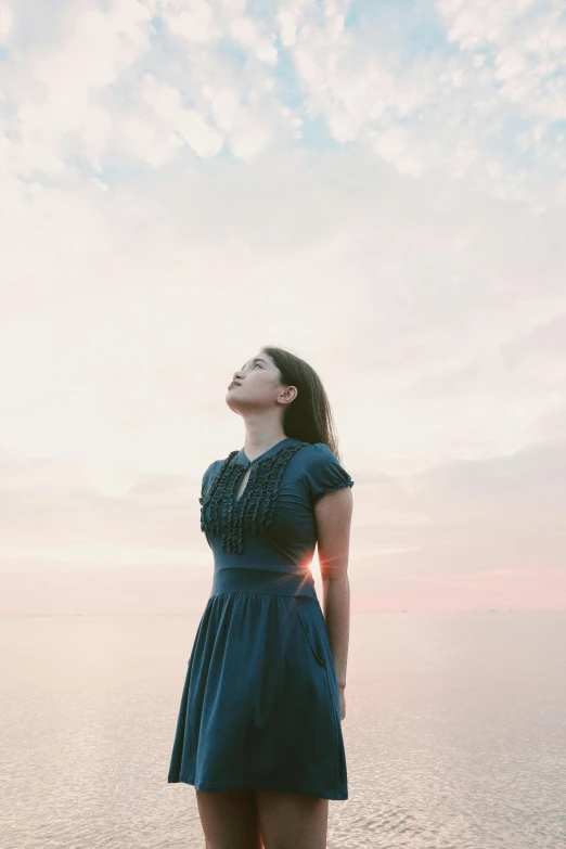 a woman standing in front of a body of water, in the sky, profile image, evening time, girl in a dress