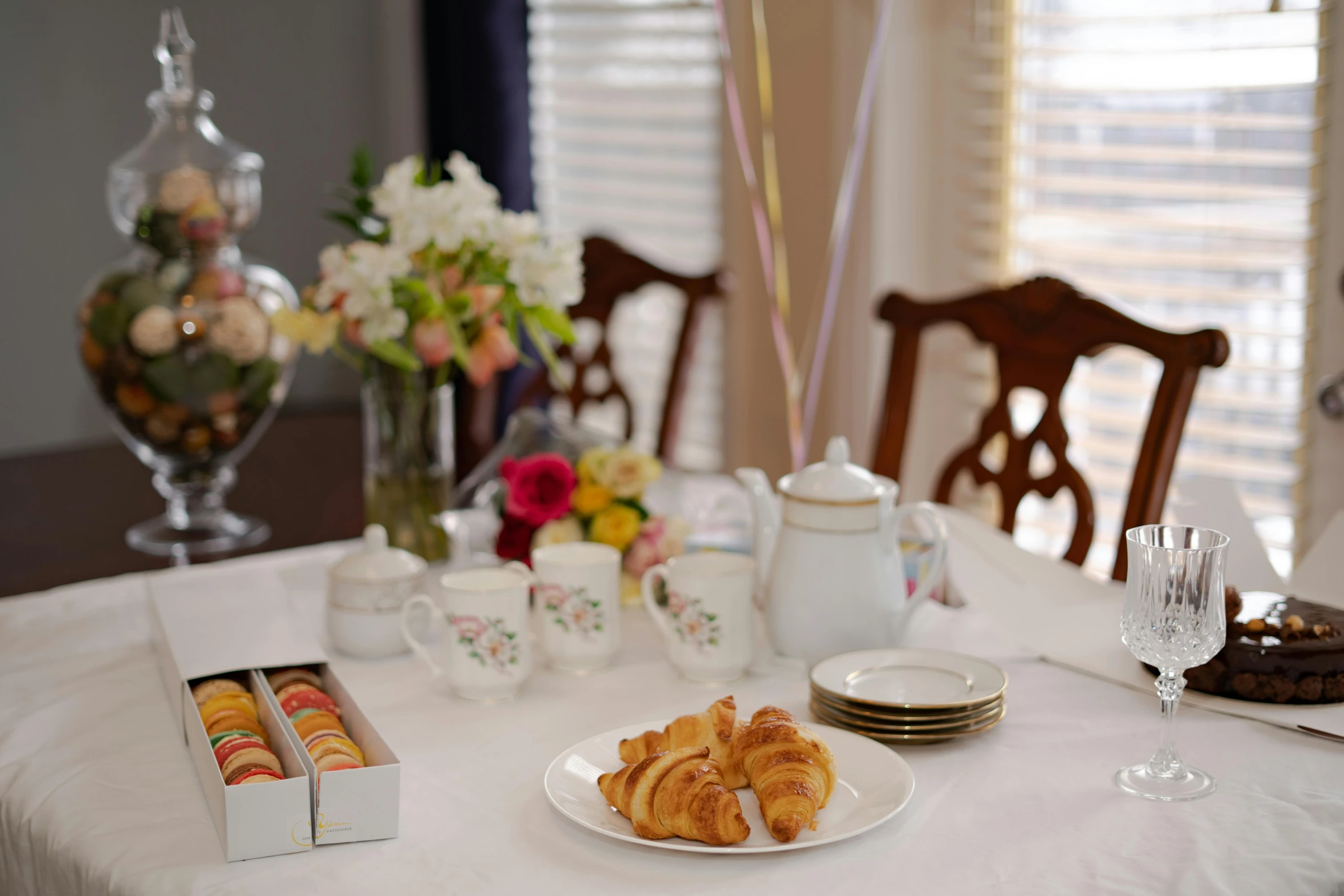 a table that has a bunch of food on it, table in front with a cup, bouquet, pastry, profile image