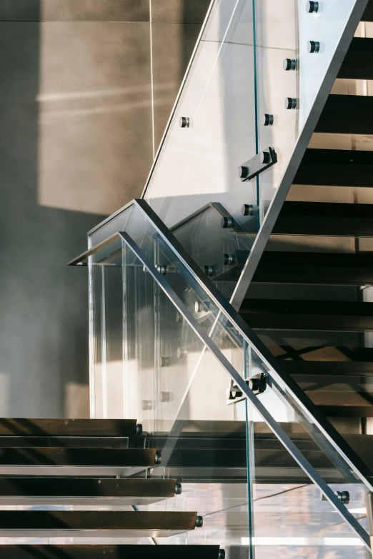 a man riding a skateboard down a flight of stairs, an abstract sculpture, by Leo Michelson, pexels contest winner, modernism, glass and steel, picture of a loft in morning, detailed light, stanchions