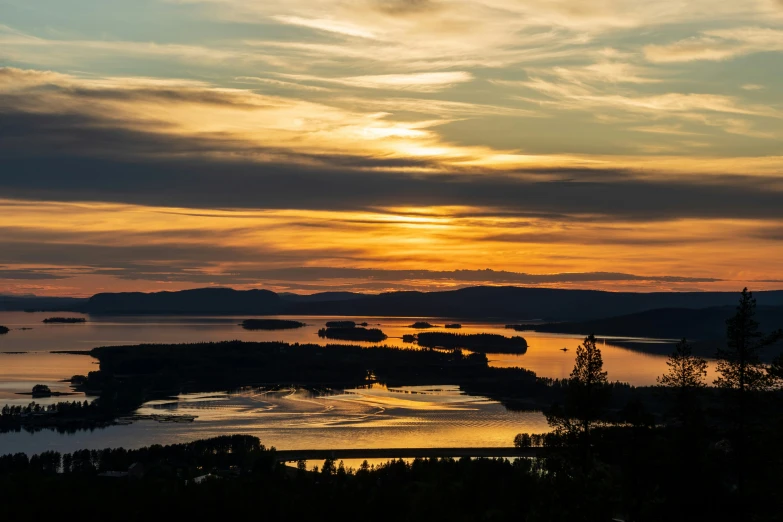 the sun is setting over a large body of water, by Anton Lehmden, pexels contest winner, archipelago, lake view, thumbnail, overview