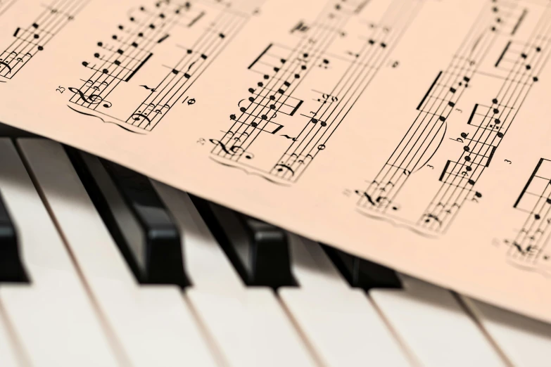 a sheet of music sitting on top of a piano keyboard, complex and intricate, what music they make, singing for you, charts