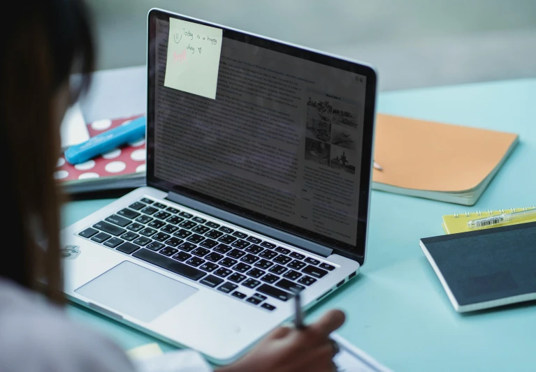 a woman sitting at a table with a laptop computer, a computer rendering, trending on unsplash, ink on post it note, medium close-up shot, school class, multiple stories