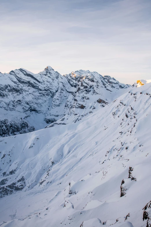 a man riding a snowboard down the side of a snow covered mountain, by Daniel Seghers, les nabis, view from high, in the evening, expansive grand scale