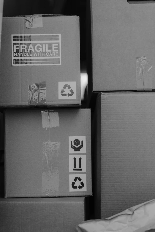 a woman sitting on the floor in front of a pile of boxes, a black and white photo, flickr, prompt: fragile looking figure, delivering parsel box, close-up photograph, inspect in inventory image