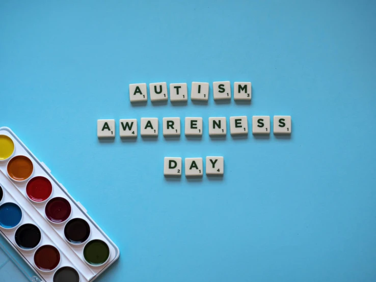 a box of paint with the words autism awareness day written on it, trending on pexels, bauhaus, background image, puzzle, schools