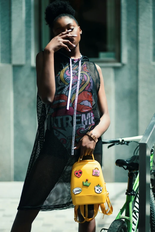 a woman standing next to a bicycle talking on a cell phone, trending on pexels, graffiti, wearing : tanktop, holding a gold bag, aida muluneh, punk rock clothes