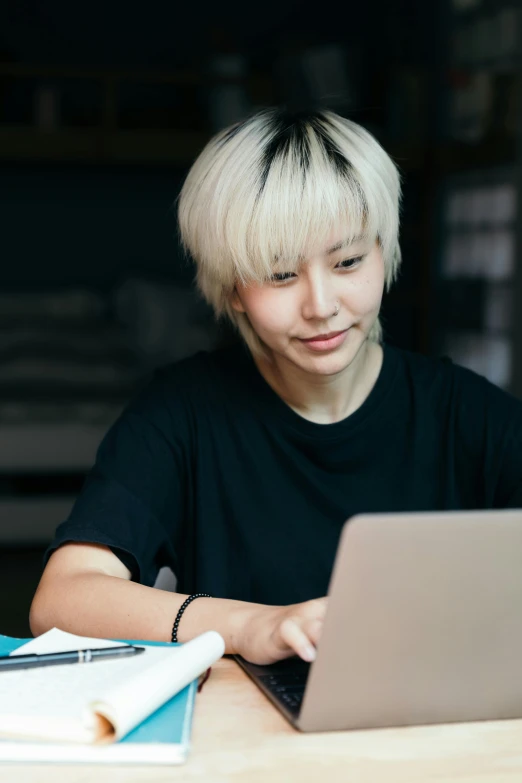 a person sitting at a table with a laptop, inspired by Li Di, trending on pexels, short platinum hair tomboy, ethnicity : japanese, studious, black