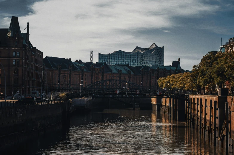 a river running through a city next to tall buildings, by Tobias Stimmer, pexels contest winner, hull is a opera house, kreuzberg, unsplash 4k, viewed from the harbor