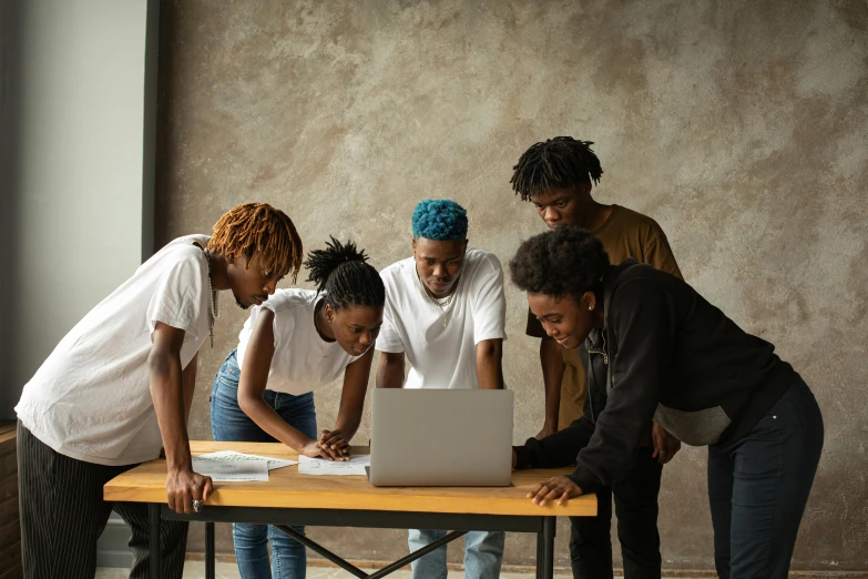 a group of people standing around a table with a laptop, trending on pexels, black arts movement, high school, thumbnail, instruction, mechanics