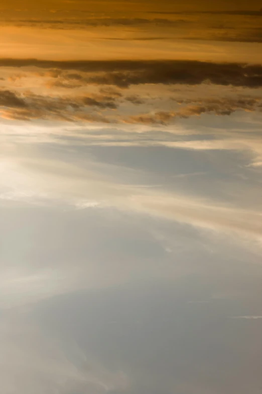 a man riding a snowboard on top of a snow covered slope, inspired by Frederic Church, lyrical abstraction, ethereal lighting - h 640, sunset in the clouds, reflections in copper, abstracted