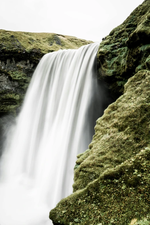 a man standing in front of a waterfall, by Daarken, full frame image, viewed from afar, super detail, f/1.4