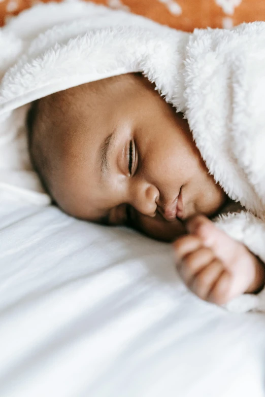 a baby sleeping under a blanket on a bed, symbolism, thumbnail, r&b, close up shot from the side, album