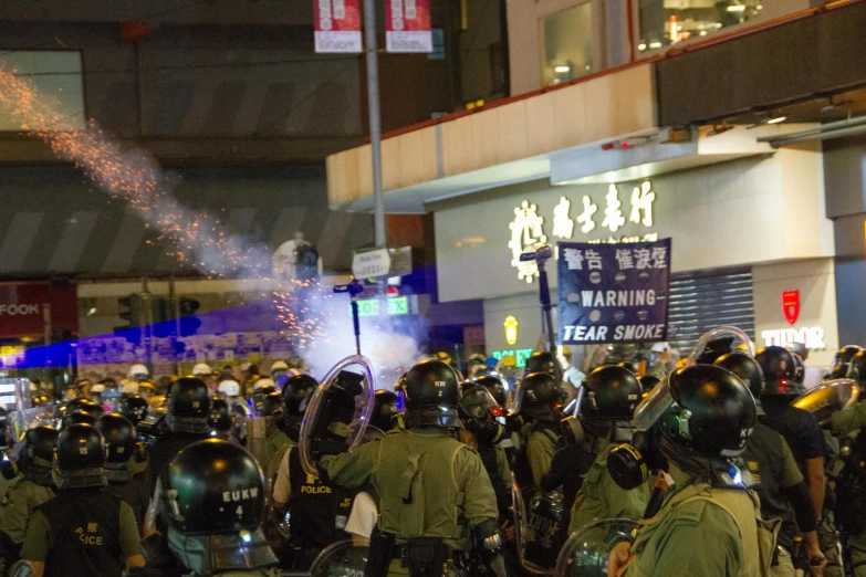 a group of people that are standing in the street, police officers under heavy fire, jeremy cheung, avatar image