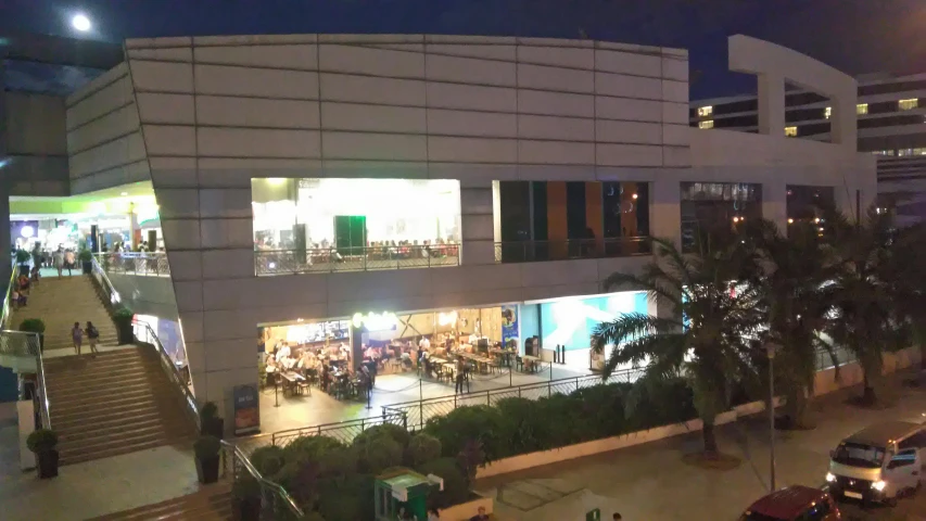 a group of cars parked in front of a building, cg society, food court, profile image, during night, 3/4 front view