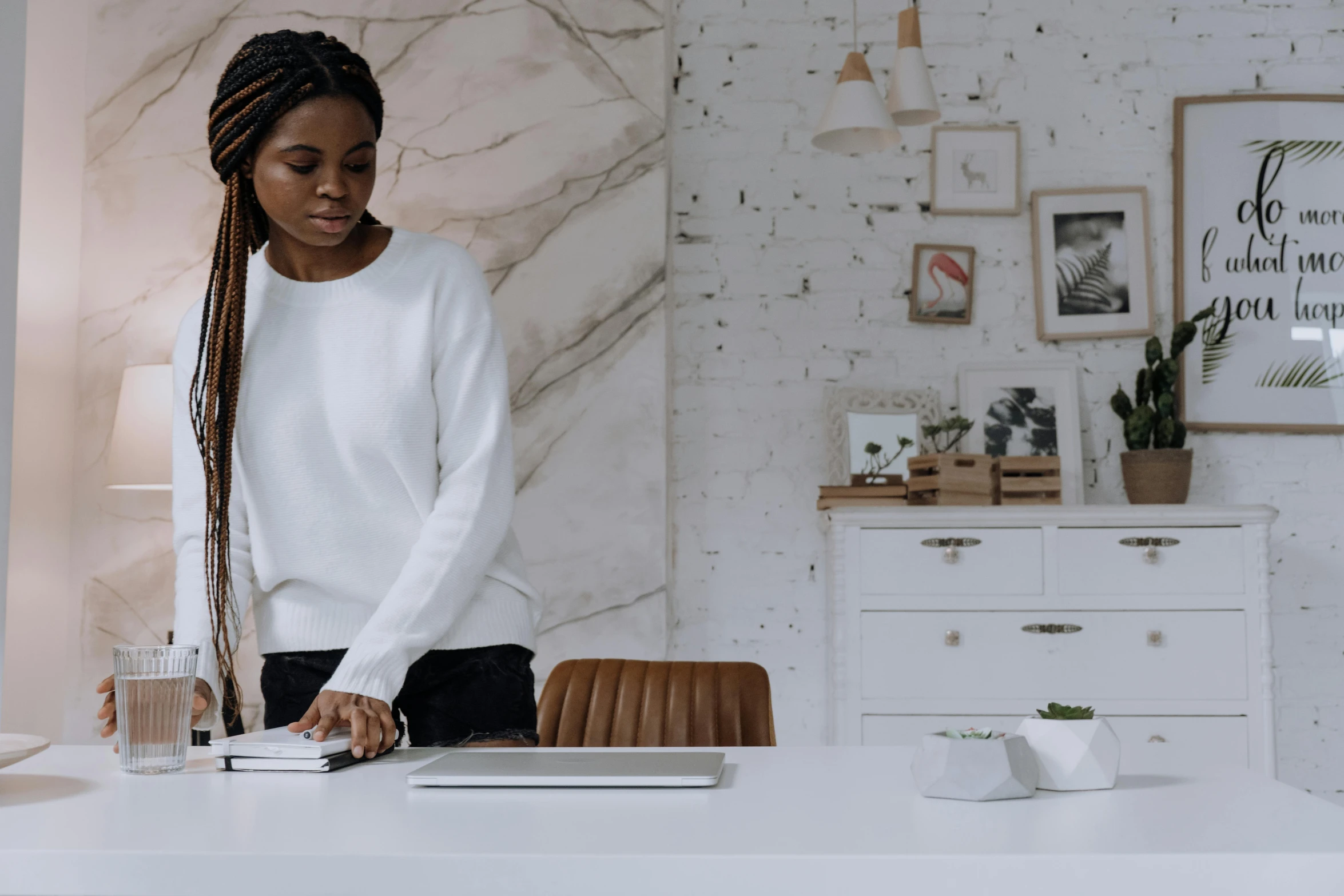 a woman standing in front of a laptop computer, by Carey Morris, trending on pexels, olivia pope, white table, tending on arstation, black young woman