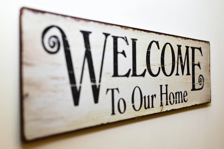 a sign that says welcome to our home, a picture, by Sam Dillemans, shutterstock, indoor picture, hq print, closeup, upscaled to high resolution