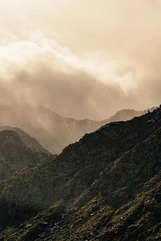 a group of people standing on top of a lush green hillside, a picture, unsplash contest winner, tonalism, chile, downpour, sepia colors, rugged face