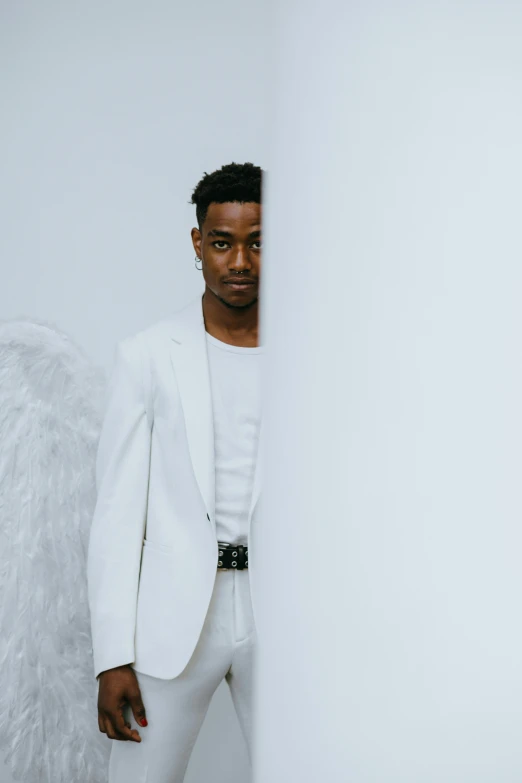 a man in a white suit and angel wings, an album cover, inspired by Xanthus Russell Smith, inside white room, playboi carti portrait, casual pose, mkbhd