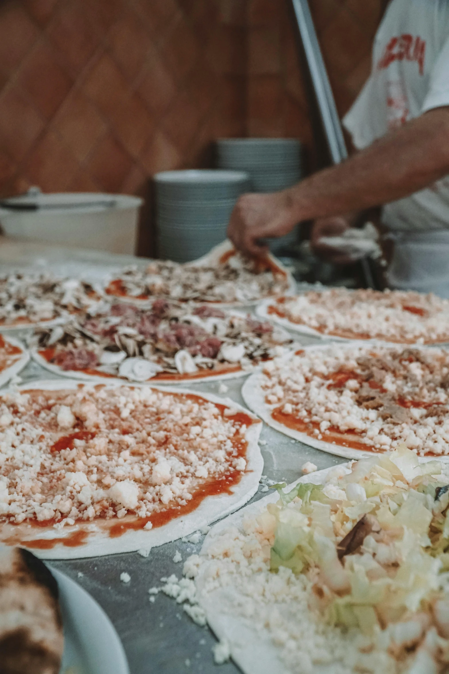 a bunch of pizzas sitting on top of a table, naples, profile image, street vendors, hands on counter