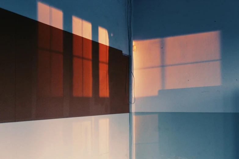 a white toilet sitting inside of a bathroom next to a window, a minimalist painting, inspired by Elsa Bleda, unsplash, gradient brown to red, light breaks through the roofs, square lines, 35mm double-exposure photo