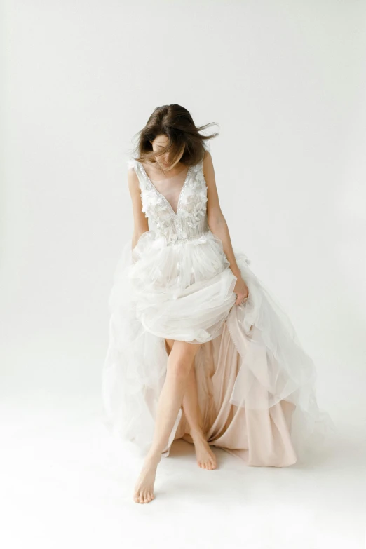 a woman in a wedding dress sitting on the floor, by Robbie Trevino, with a white background, julia sarda, walking towards camera, fairy