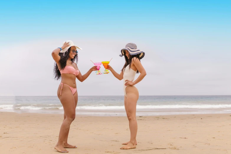 a couple of women standing on top of a sandy beach, by Arabella Rankin, pexels contest winner, renaissance, drink milkshakes together, monokini, parody, coming out of the ocean