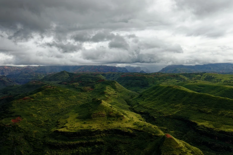 the view from the top of a hill on a cloudy day, a matte painting, pexels contest winner, hurufiyya, madagascar, green, kauai, natural overcast lighting