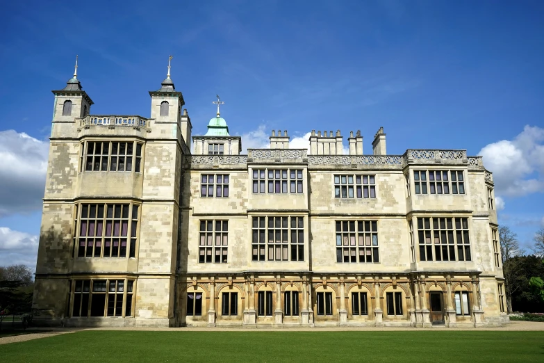 a large building sitting on top of a lush green field, inspired by Isabel Codrington, arts and crafts movement, ivory towers, courtyard, smooth panelling, getty images proshot