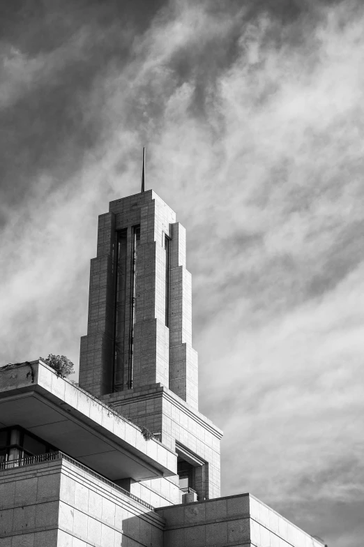 a black and white photo of a building, inspired by Hugh Ferriss, unsplash, brutalism, lead - covered spire, bright sky, temple of the sun, 8k 50mm iso 10