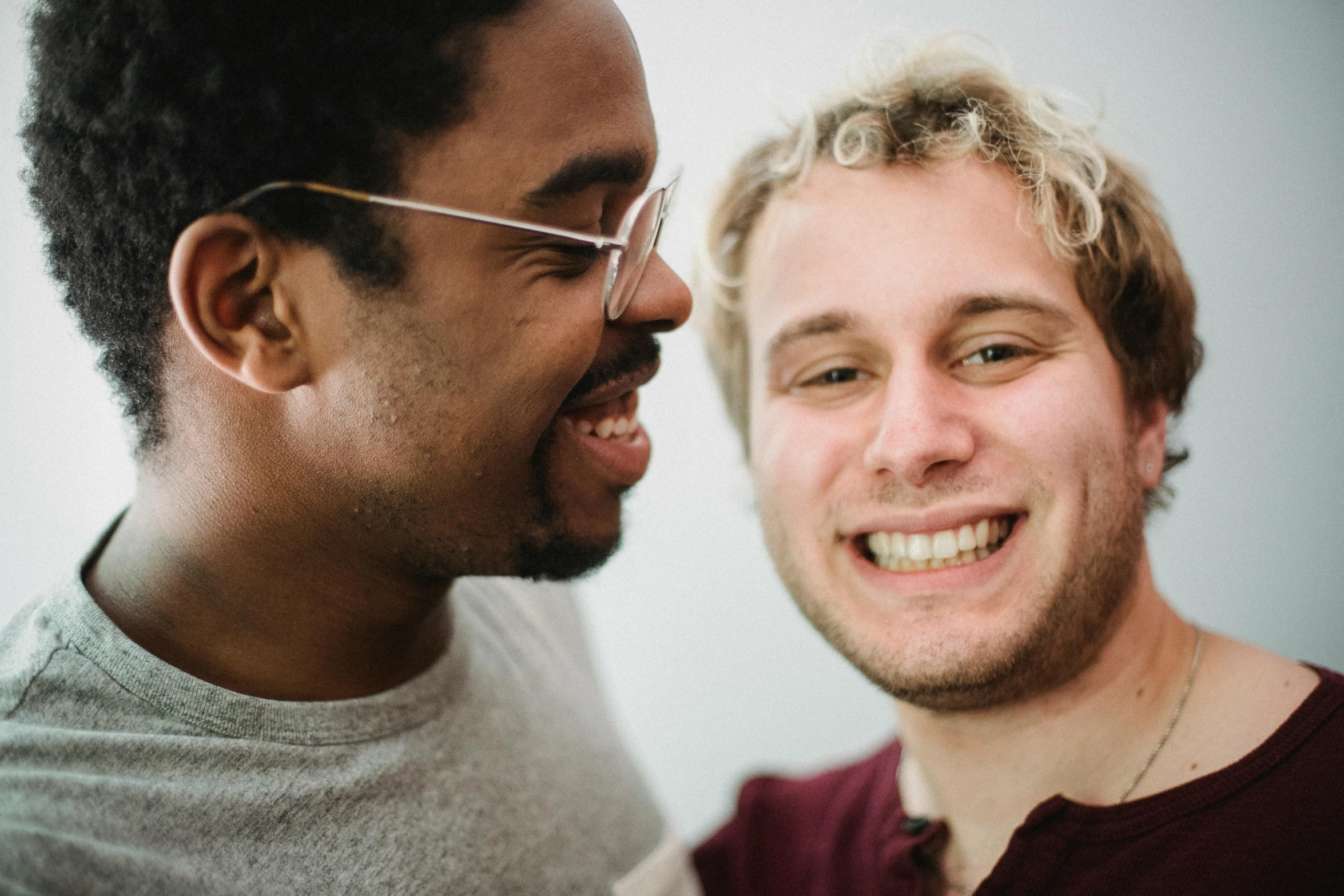 a couple of men standing next to each other, pexels contest winner, smiling mouth, pale skin curly blond hair, varying ethnicities, mouth agape