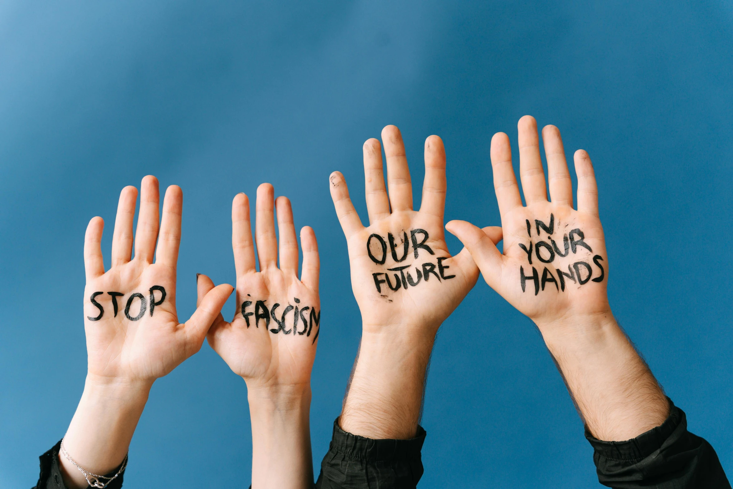 a group of people holding up their hands with words written on them, by Julia Pishtar, trending on pexels, hands on face, 15081959 21121991 01012000 4k, four arms, hyperealistic