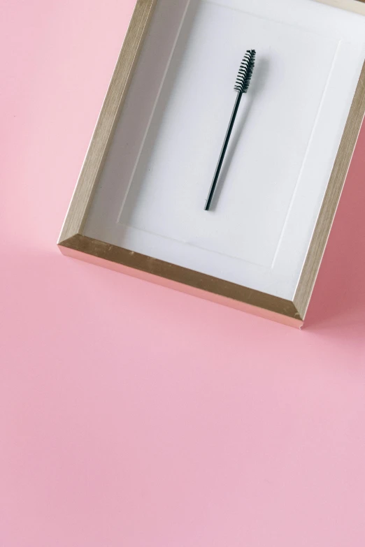 a toothbrush in a box on a pink surface, a minimalist painting, trending on unsplash, postminimalism, clock iconography, square pictureframes, high angle close up shot, very elongated lines
