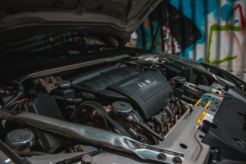 a close up of a car engine with its hood open, instagram post, diagnostics, black car, gm