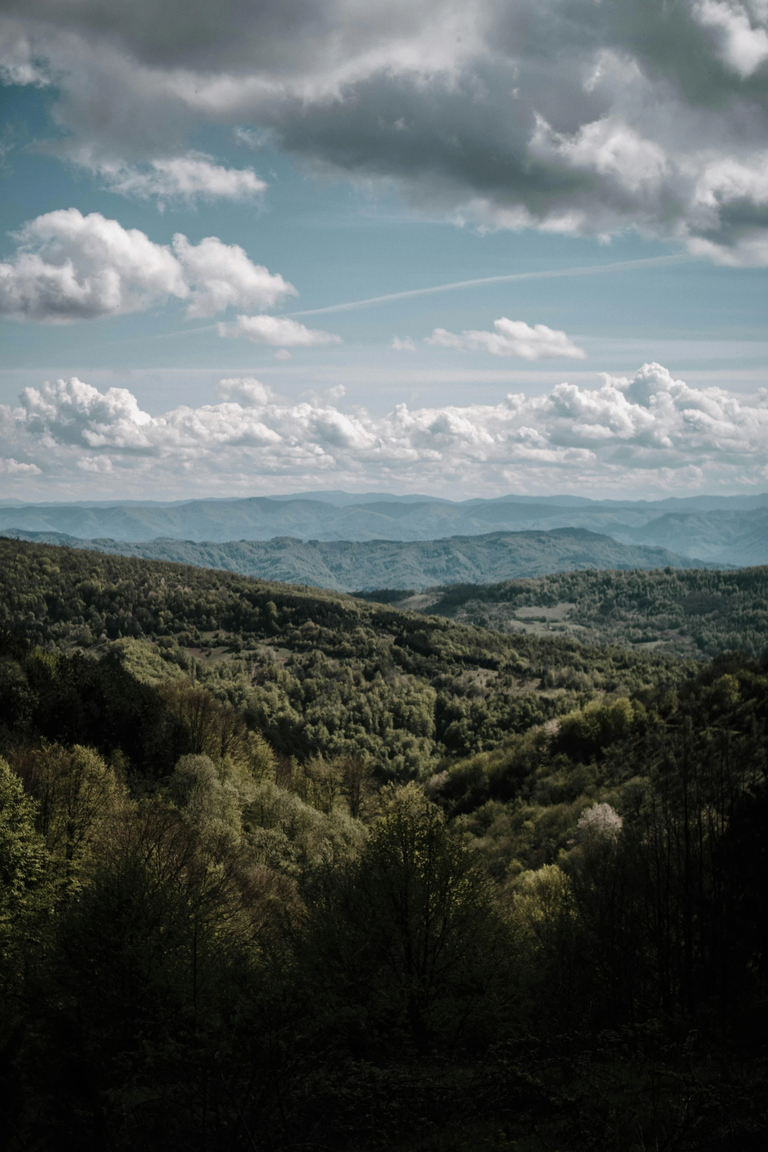 a view of the mountains from the top of a hill, by Adam Marczyński, appalachian mountains, high view, near forest, skies