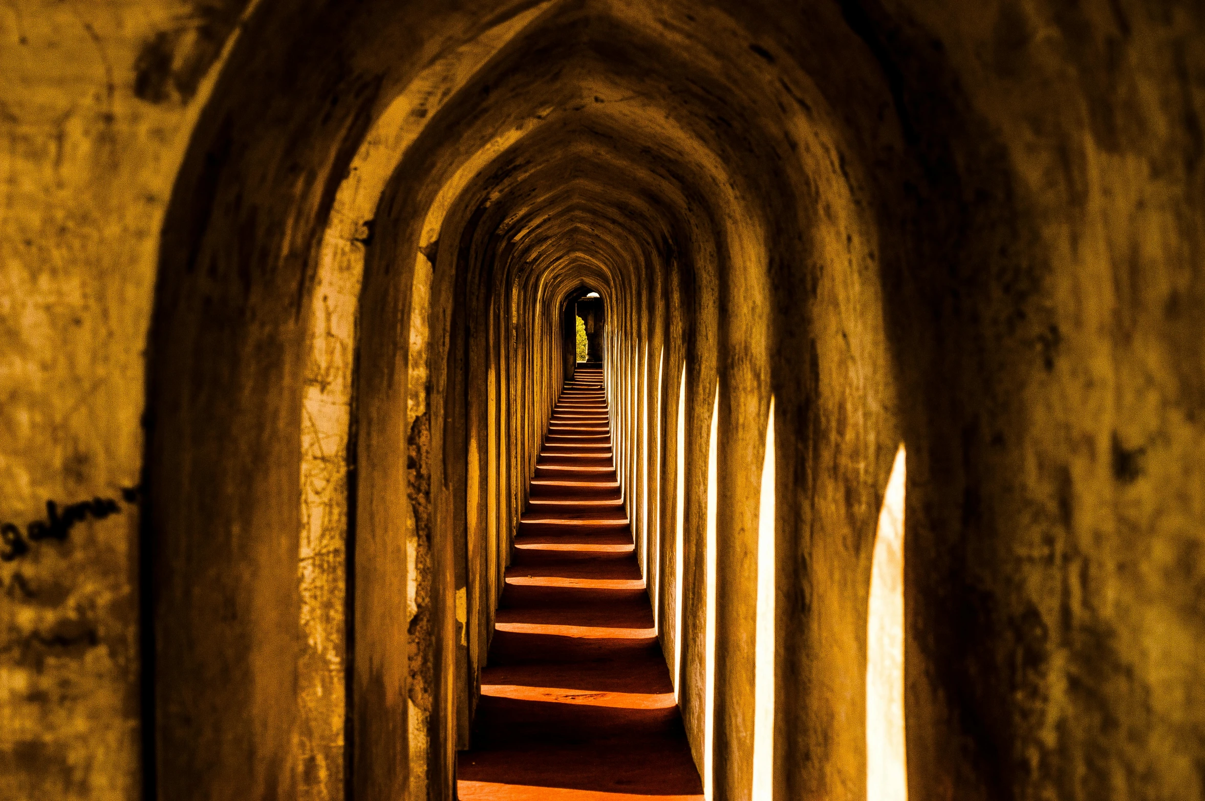 a long row of stairs in a tunnel, an album cover, inspired by Steve McCurry, pexels contest winner, conceptual art, buddhist architecture, brown, high arches, thumbnail