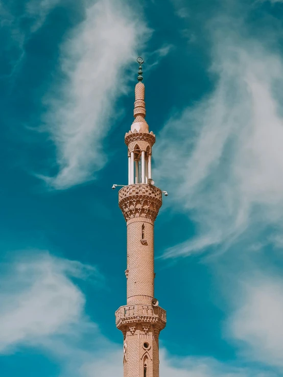 a tall tower with a clock on top of it, by Ismail Acar, unsplash contest winner, hurufiyya, hijab, sky blue, paisley, profile image