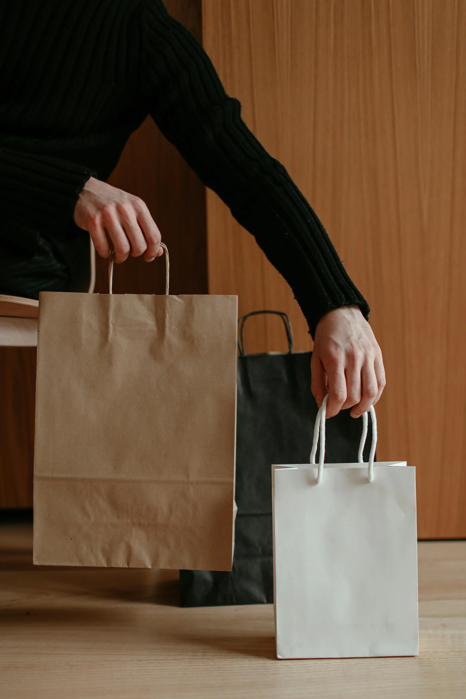 a woman sitting on the floor with shopping bags, pexels contest winner, renaissance, a man wearing a black jacket, sitting on a mocha-colored table, sleek hands, minimalistic