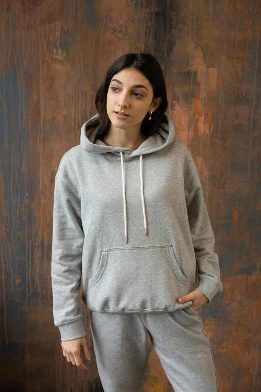 a woman standing with her hands in her pockets, a portrait, featured on reddit, wearing a grey hooded sweatshirt, thumbnail, modeled, f / 2 0