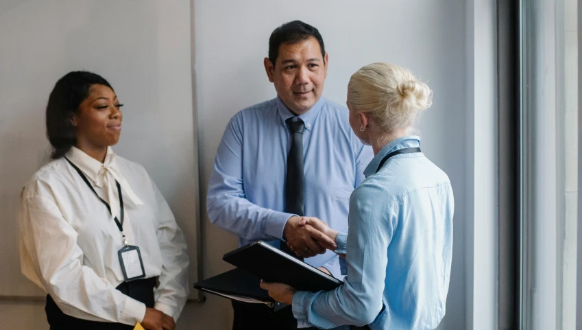 two people shaking hands in front of a window, darren quach, health supporter, amanda lilleston, doctors office