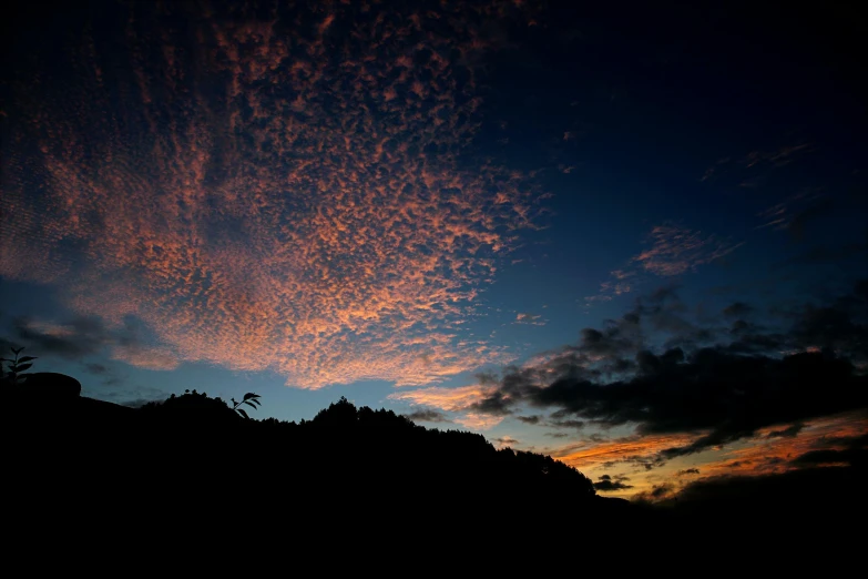 a sunset with some clouds in the sky, by Peter Churcher, unsplash, sumatraism, on black background, craggy, slide show, panorama