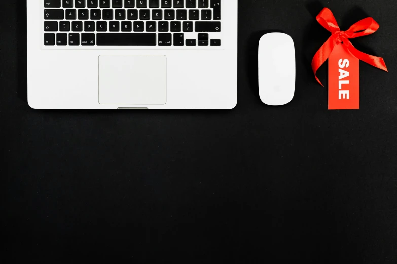 a laptop computer sitting on top of a desk next to a mouse, by Carey Morris, pexels contest winner, computer art, black and red, holiday, flat lay, white on black