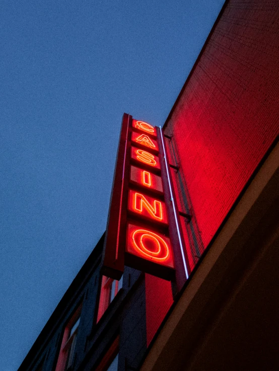 a neon sign on the side of a building, by Matt Cavotta, trending on unsplash, casino, show from below, profile image