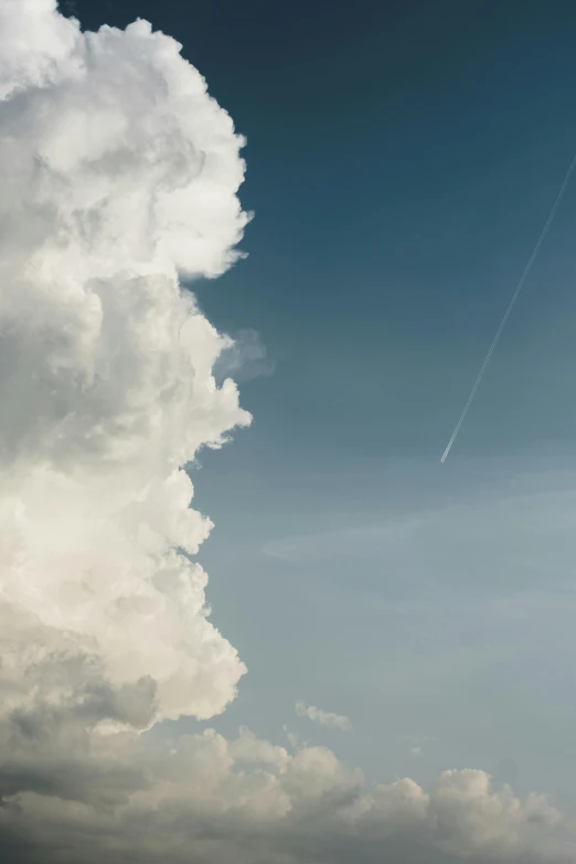 a person flying a kite on a cloudy day, by Peter Churcher, unsplash contest winner, postminimalism, giant cumulonimbus cloud, high angle vertical, meteor, in profile