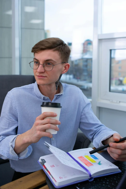 a man sitting at a desk with a cup of coffee, trending on reddit, an epic non - binary model, russian academic, high quality photo, office clothes