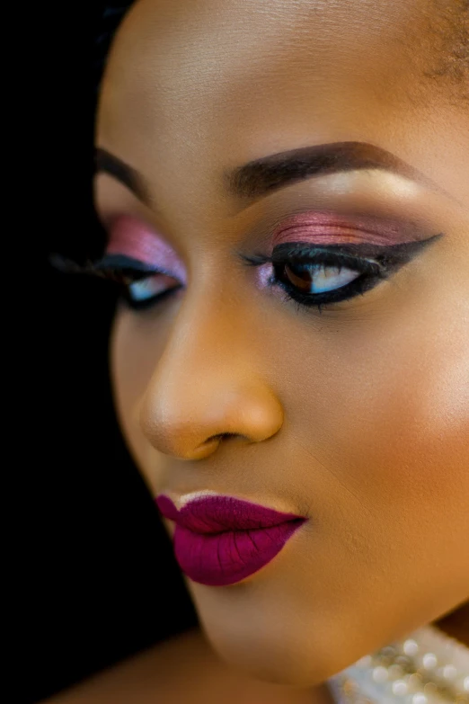 a close up of a woman with a pearl necklace, an album cover, by Chinwe Chukwuogo-Roy, trending on pexels, brown and magenta color scheme, pout, eye shadow, fierce expression 4k